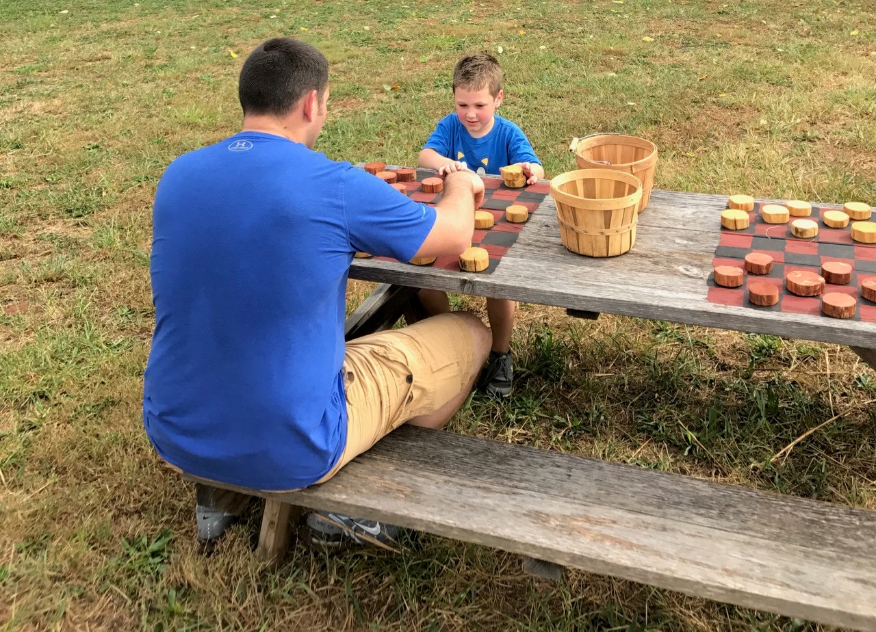 Father-son checkers game at Huckleberry Trail Farm.